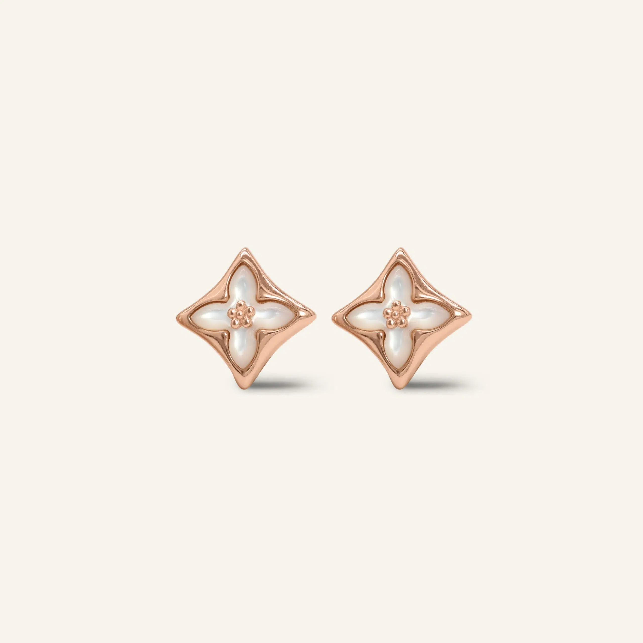 Close-up of a pair of rose gold clover monogram studs