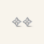 Close-up of a pair of silver clover monogram studs