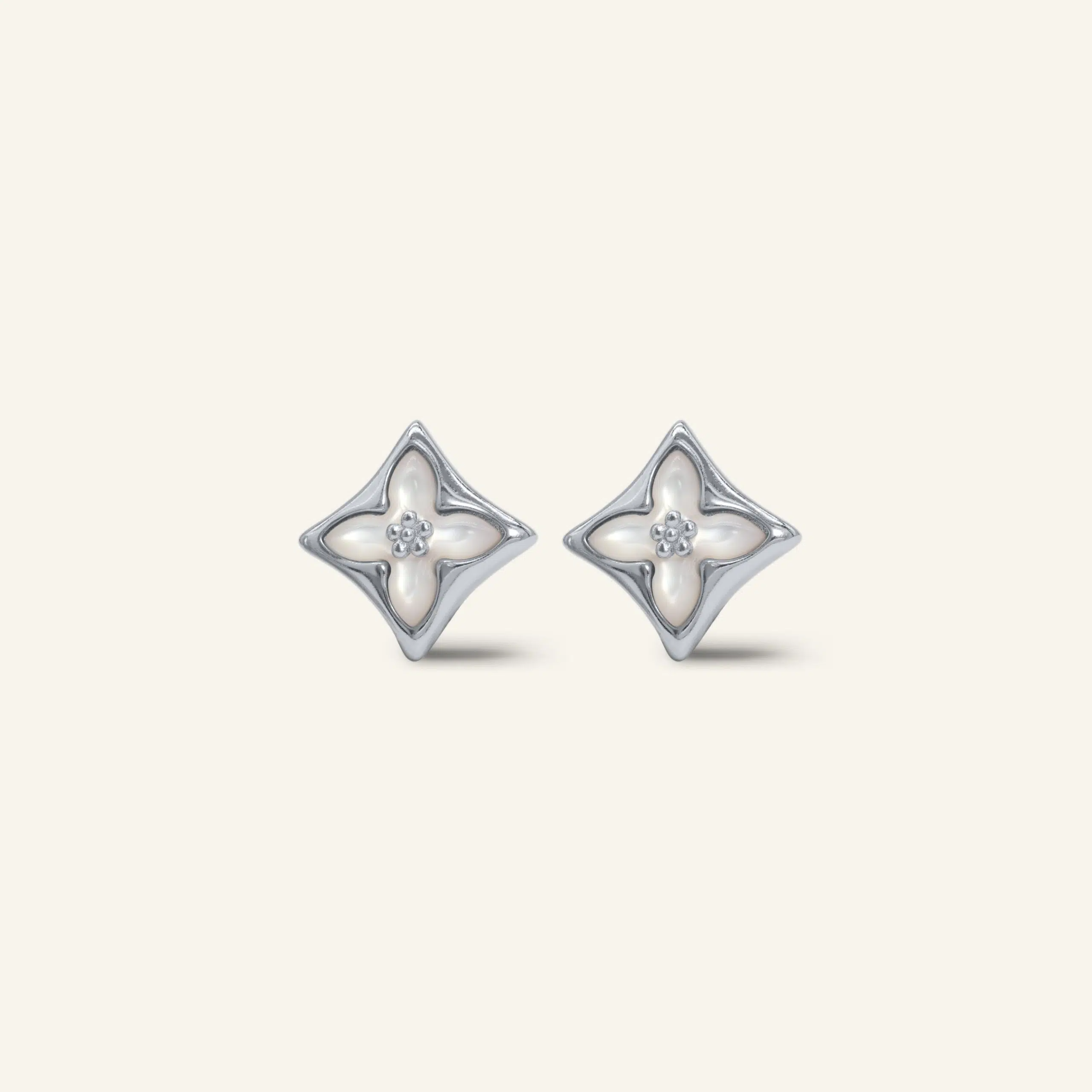 Close-up of a pair of silver clover monogram studs