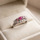 Silver pink gemstone bow ring displayed in an ivory jewelry box