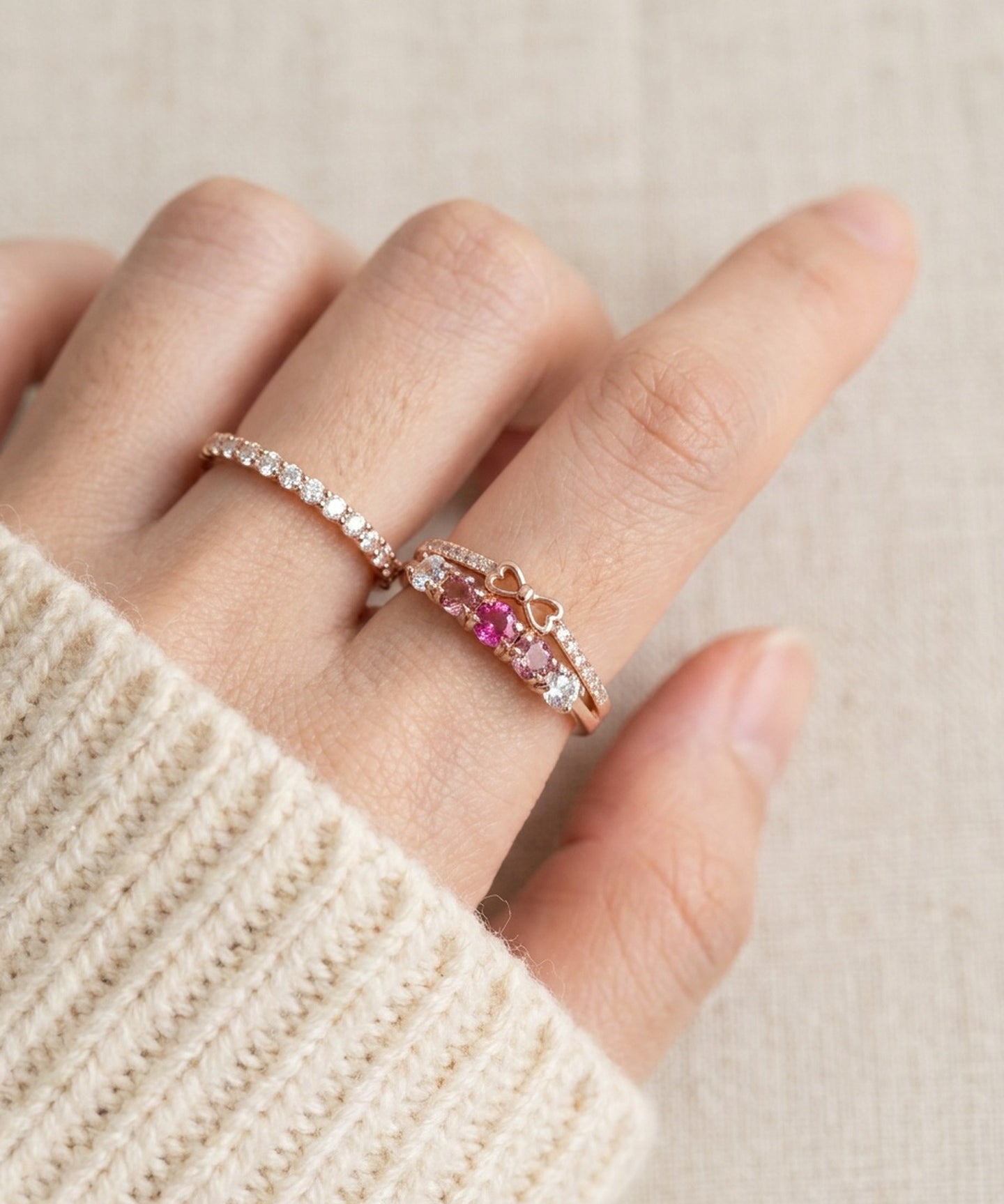 Pink gemstone double band bow ring styled on hand