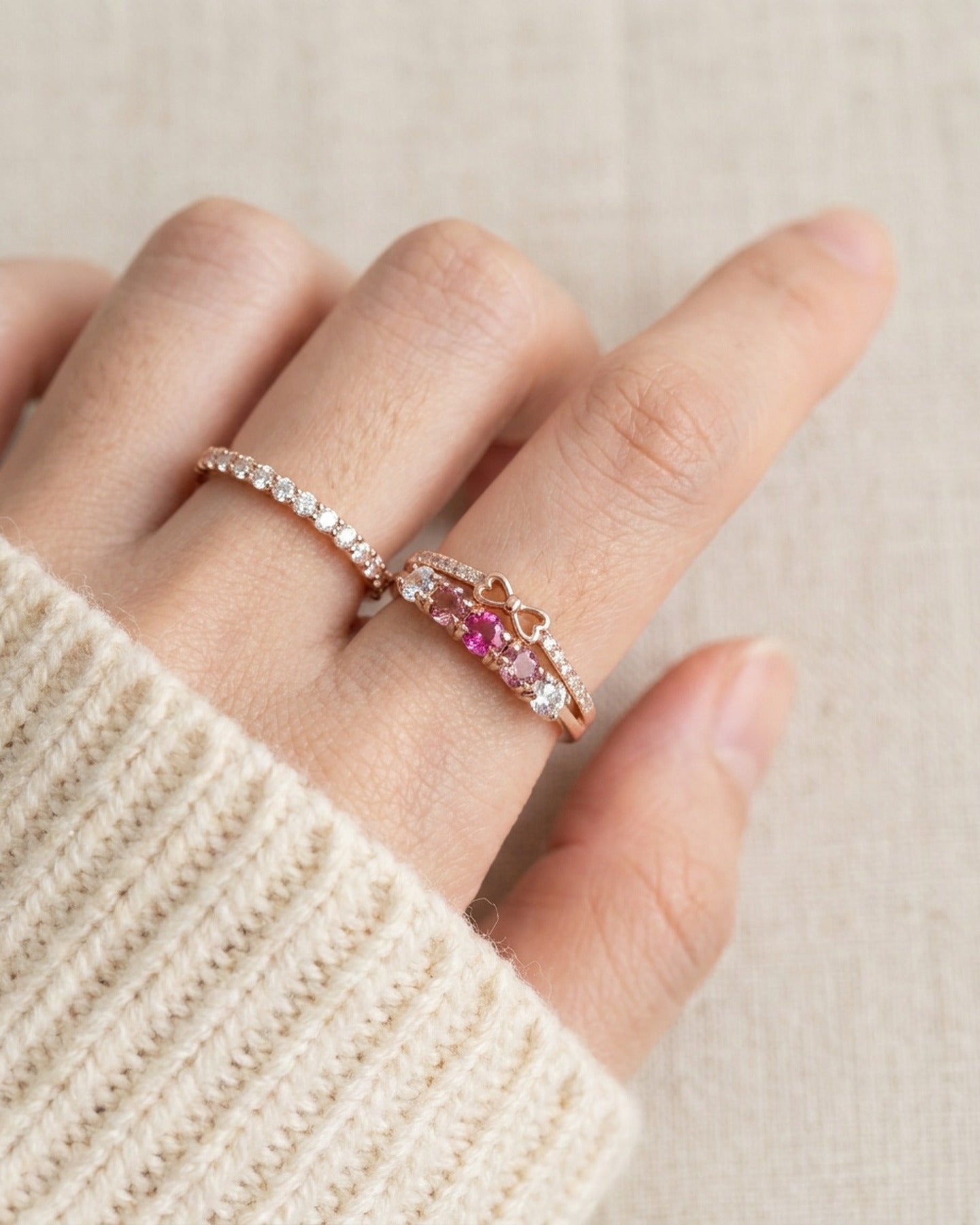 Pink gemstone double band bow ring styled on hand