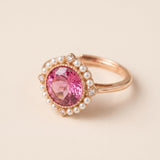 Duchess Pink Topaz Ring in rose gold shown from the side with pink topaz and faux pearl halo