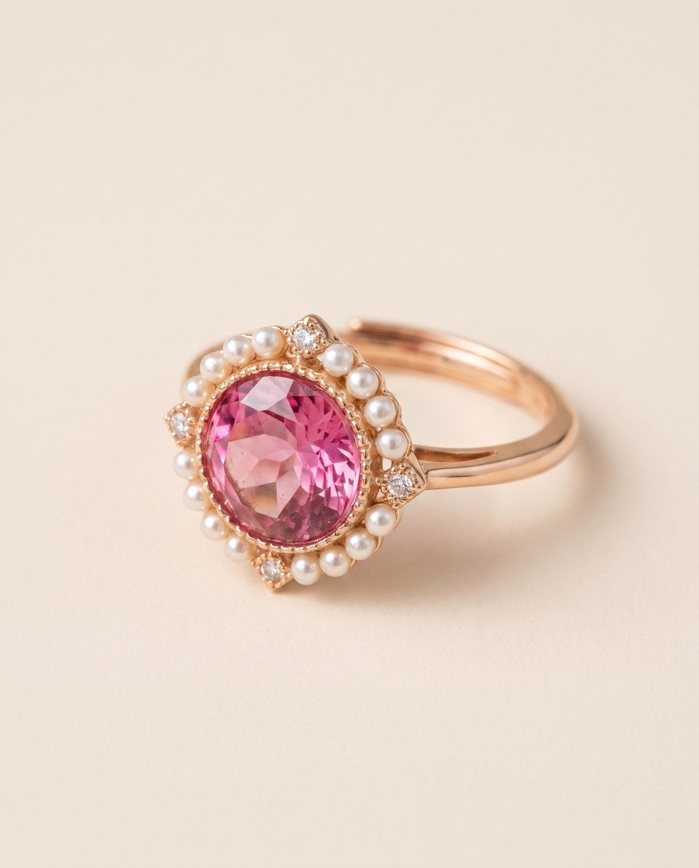 Duchess Pink Topaz Ring in rose gold shown from the side with pink topaz and faux pearl halo