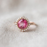 Close-up of Duchess Pink Topaz Ring in rose gold on soft ivory linen