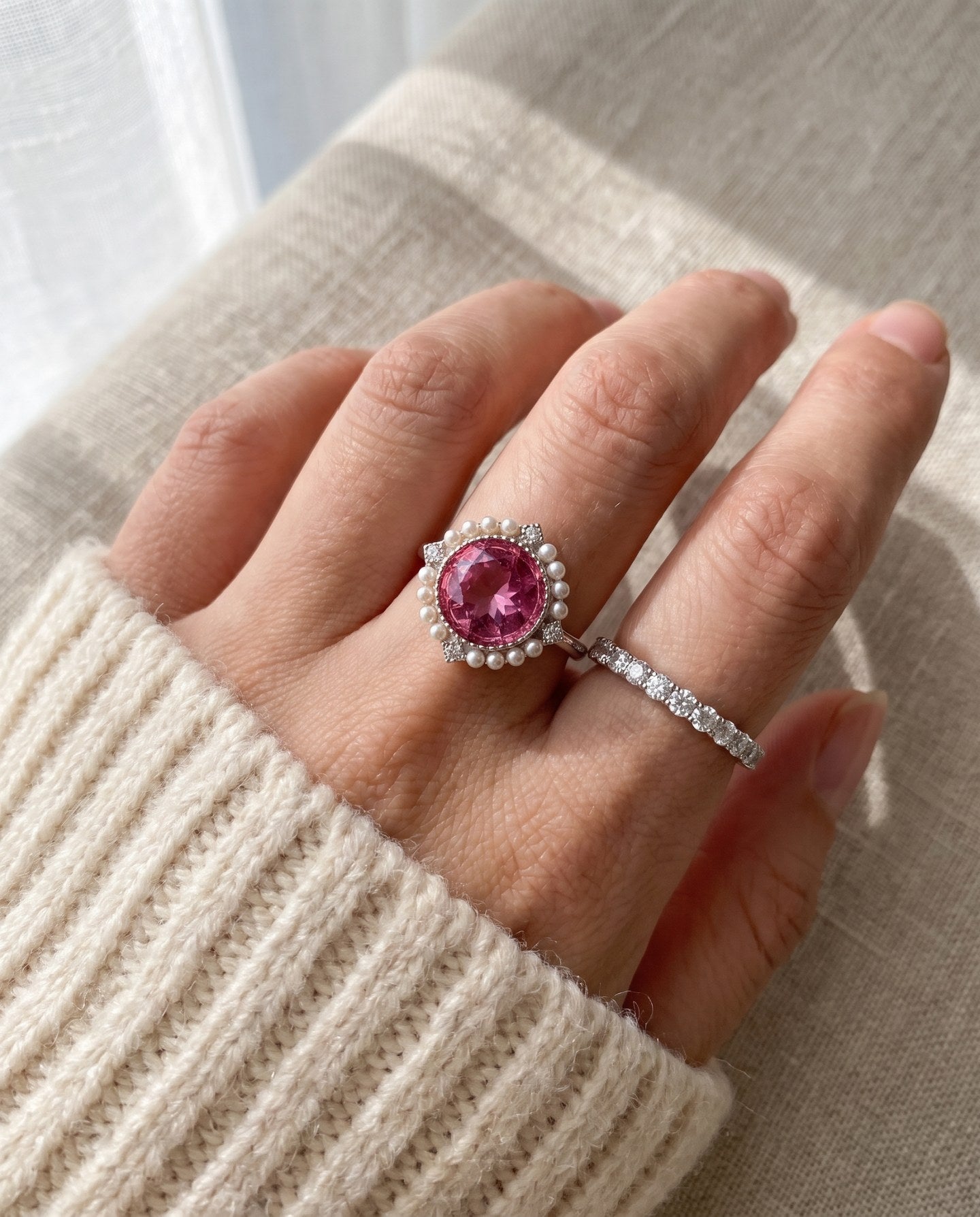 Duchess Pink Topaz Ring in silver worn with a delicate stacking ring in natural sunlight