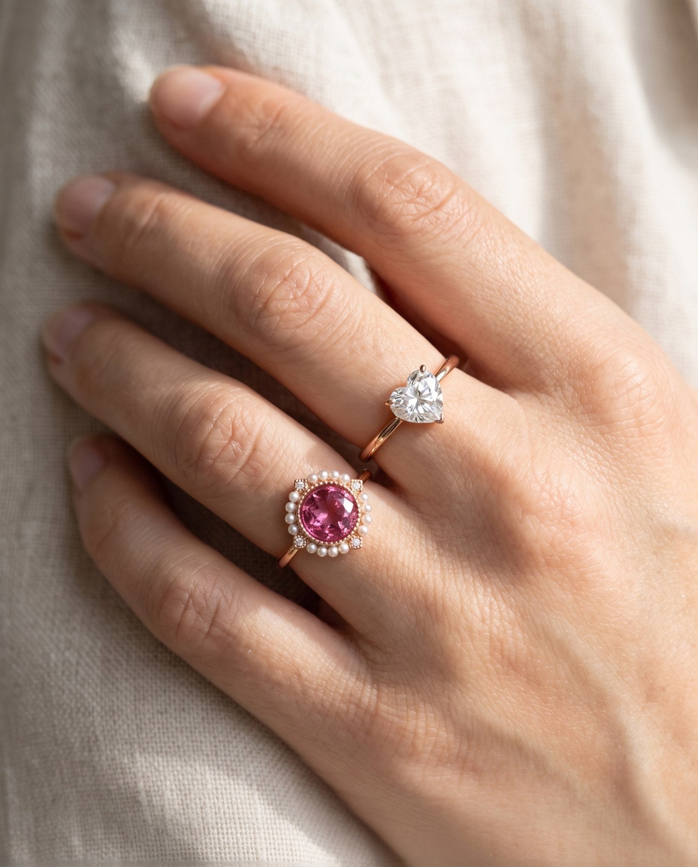 Duchess Pink Topaz Ring styled on hand with a heart-cut ring in warm natural light