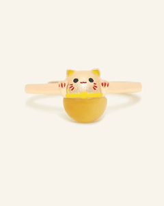 Close-up of the Fortune Cat Ring in Tiger Eye, resting on a warm linen background