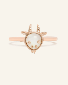 Close-up of the Goat Zodiac Ring in Mother of Pearl, resting on a warm linen background