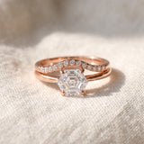 Hexagon step-cut moissanite ring in rose gold styled on ivory linen with stacking rings
