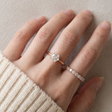 Hexagon step-cut moissanite ring in rose gold worn on a hand