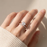 Hexagon step-cut moissanite ring in rose gold worn on a hand