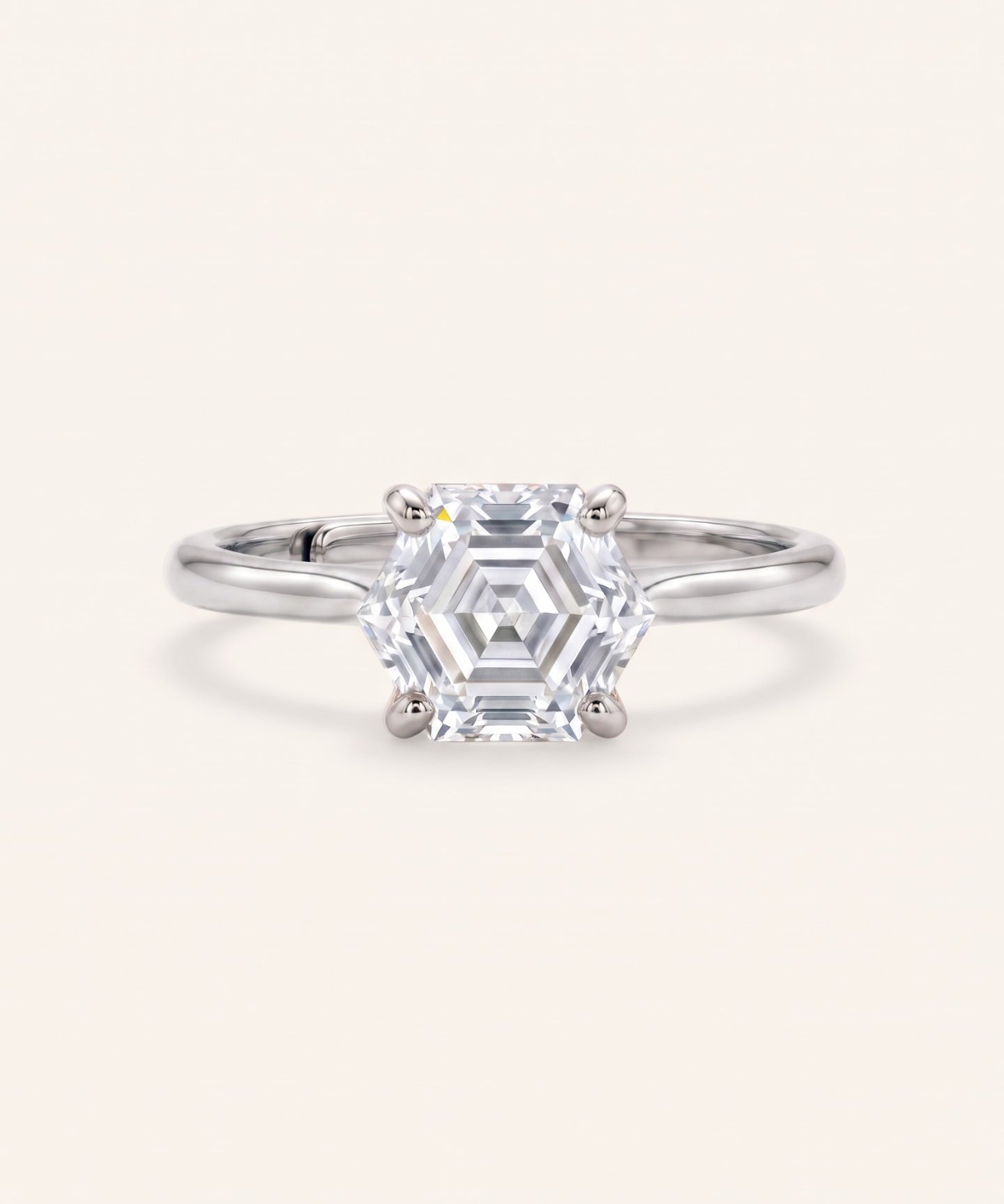 Hexagon step-cut moissanite ring in silver on an ivory background
