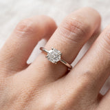 Hexagon step-cut moissanite ring in silver worn on a hand