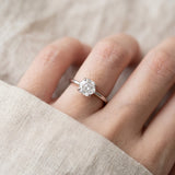 Hexagon step-cut moissanite ring in silver worn on a hand