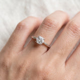 Hexagon step-cut moissanite ring in silver worn on a hand
