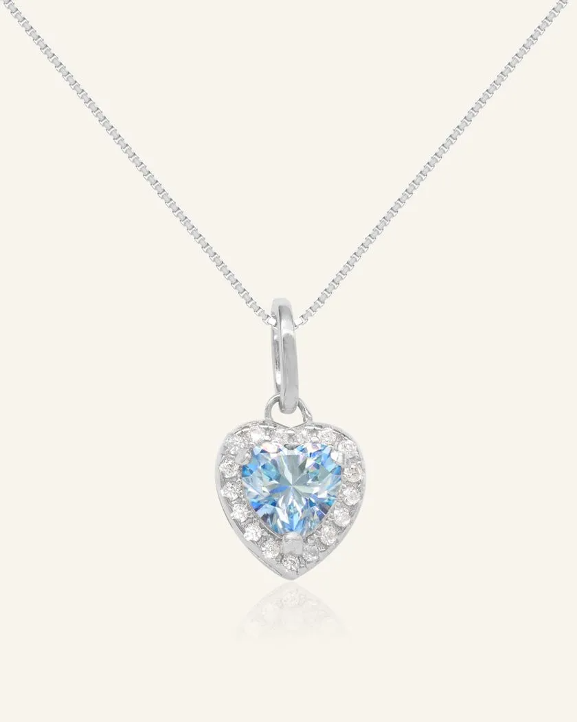 A necklace featuring a heart-shaped pendant with a heart-shaped ice blue moissanite at its center, surrounded by a halo of smaller cubic zirconias. The pendant is suspended from a fine chain, all crafted in rhodium vermeil for a luxurious finish.