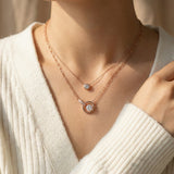 Rose gold interlocking rings moissanite necklace layered with a solitaire necklace