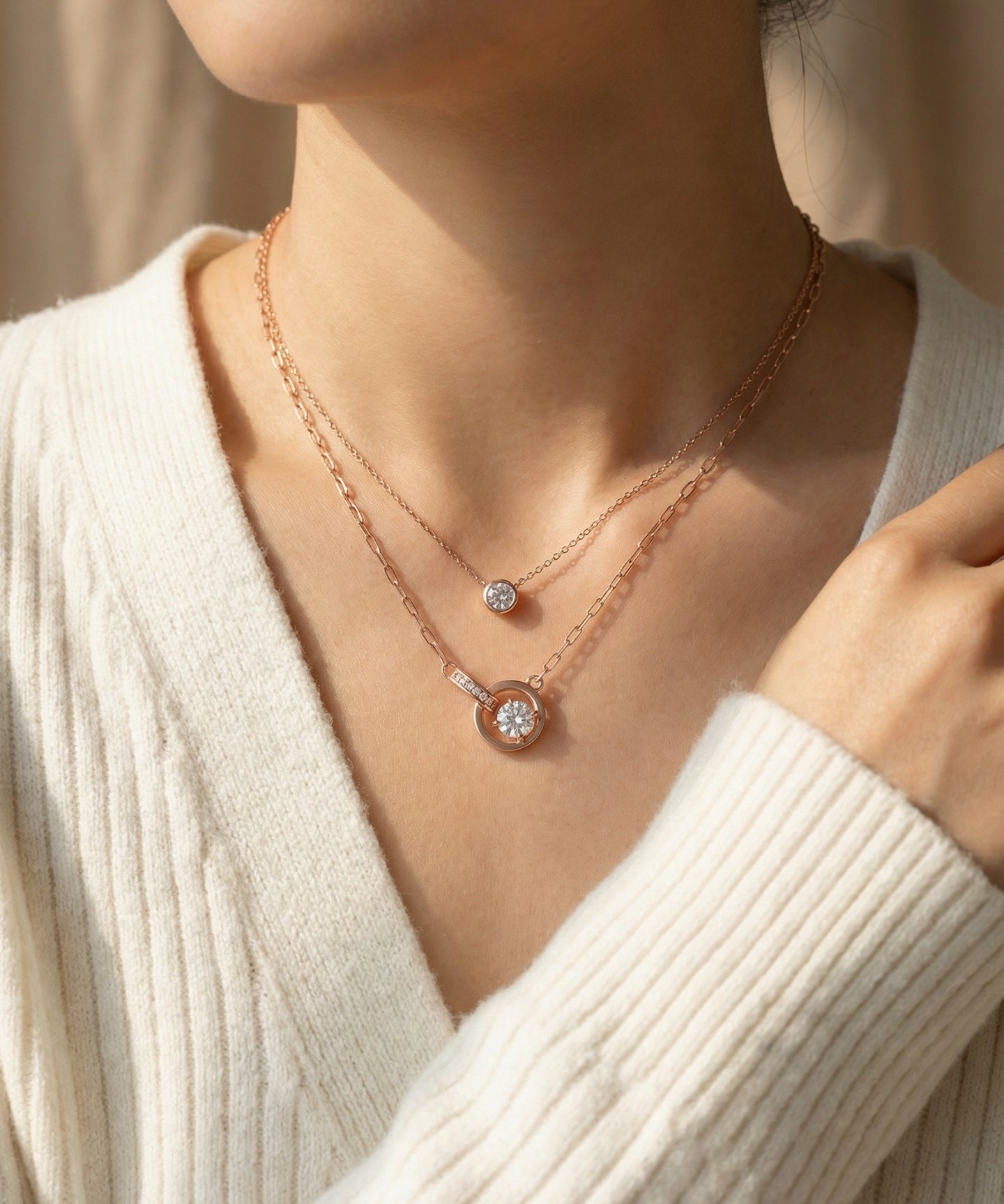 Rose gold interlocking rings moissanite necklace layered with a solitaire necklace