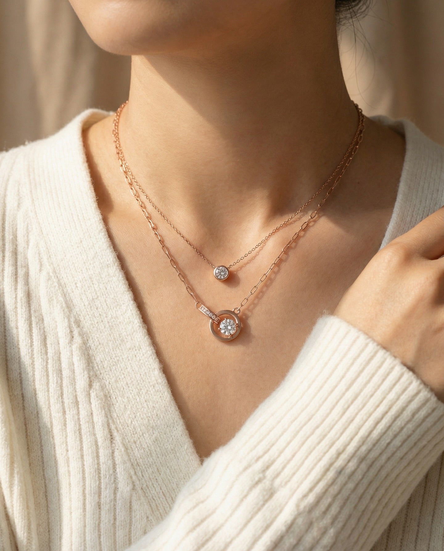 Rose gold interlocking rings moissanite necklace layered with a solitaire necklace