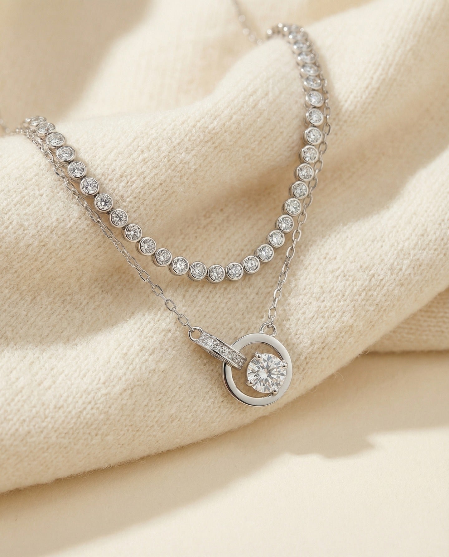 Silver interlocking rings moissanite necklace styled with a tennis necklace