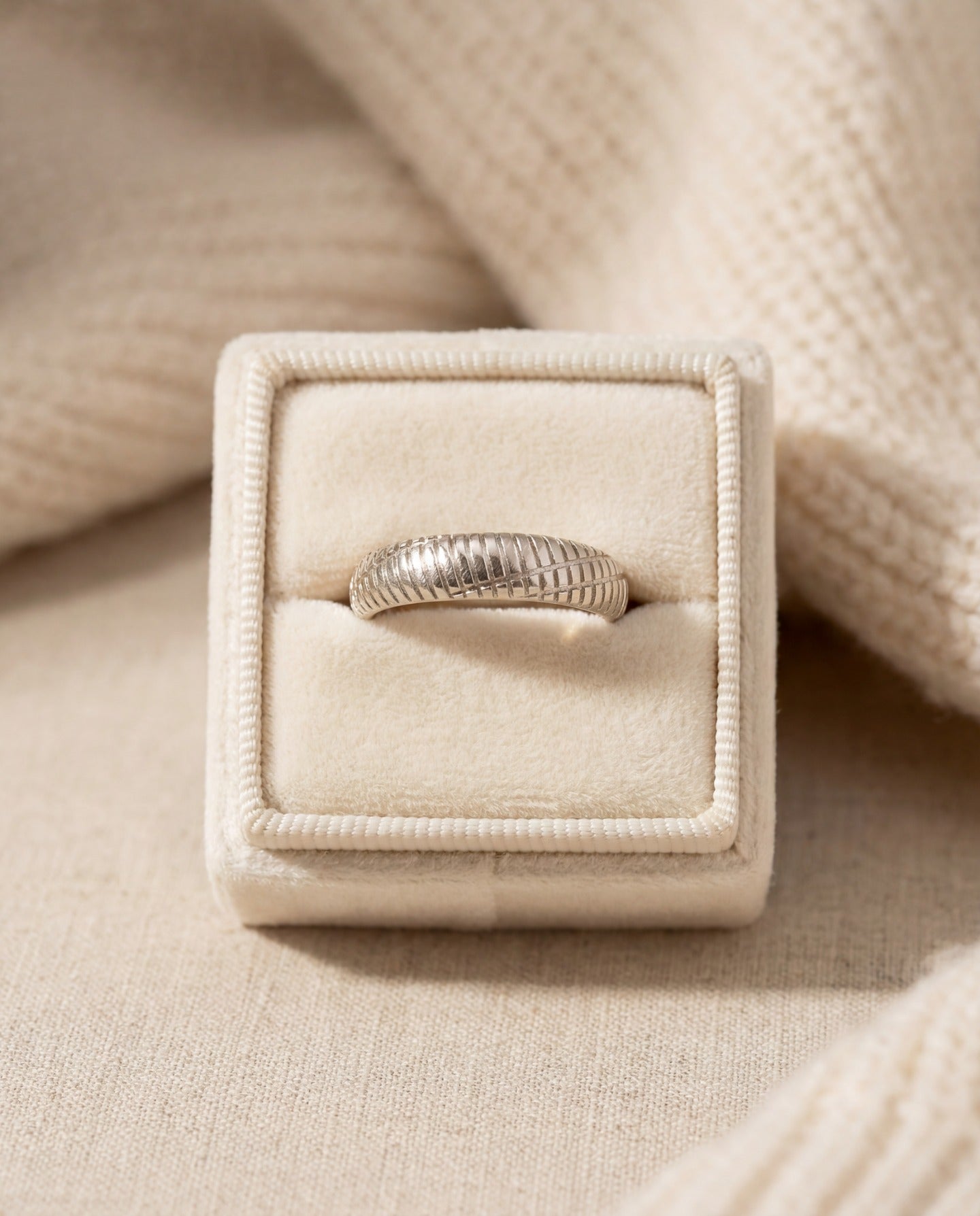 Linear Stripes Band in silver, displayed upright in a cream ring box