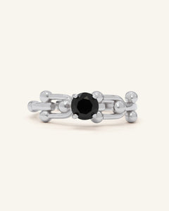 Lock Link Ring | Black Spinel, Elate, resting on a warm linen background