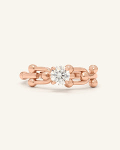Lock Link Ring | White Moissanite, Elate, resting on a warm linen background