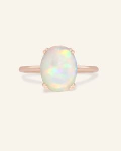 Close-up of the Luna Opal Ring, resting on a warm linen background