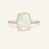 Luna Ethiopian Opal Ring in rose gold, front view of the oval opal ring on warm ivory