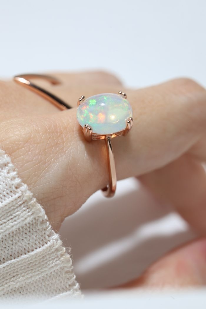 Luna Ethiopian Opal Ring in rose gold, side-angle close-up of the opal setting worn on a hand