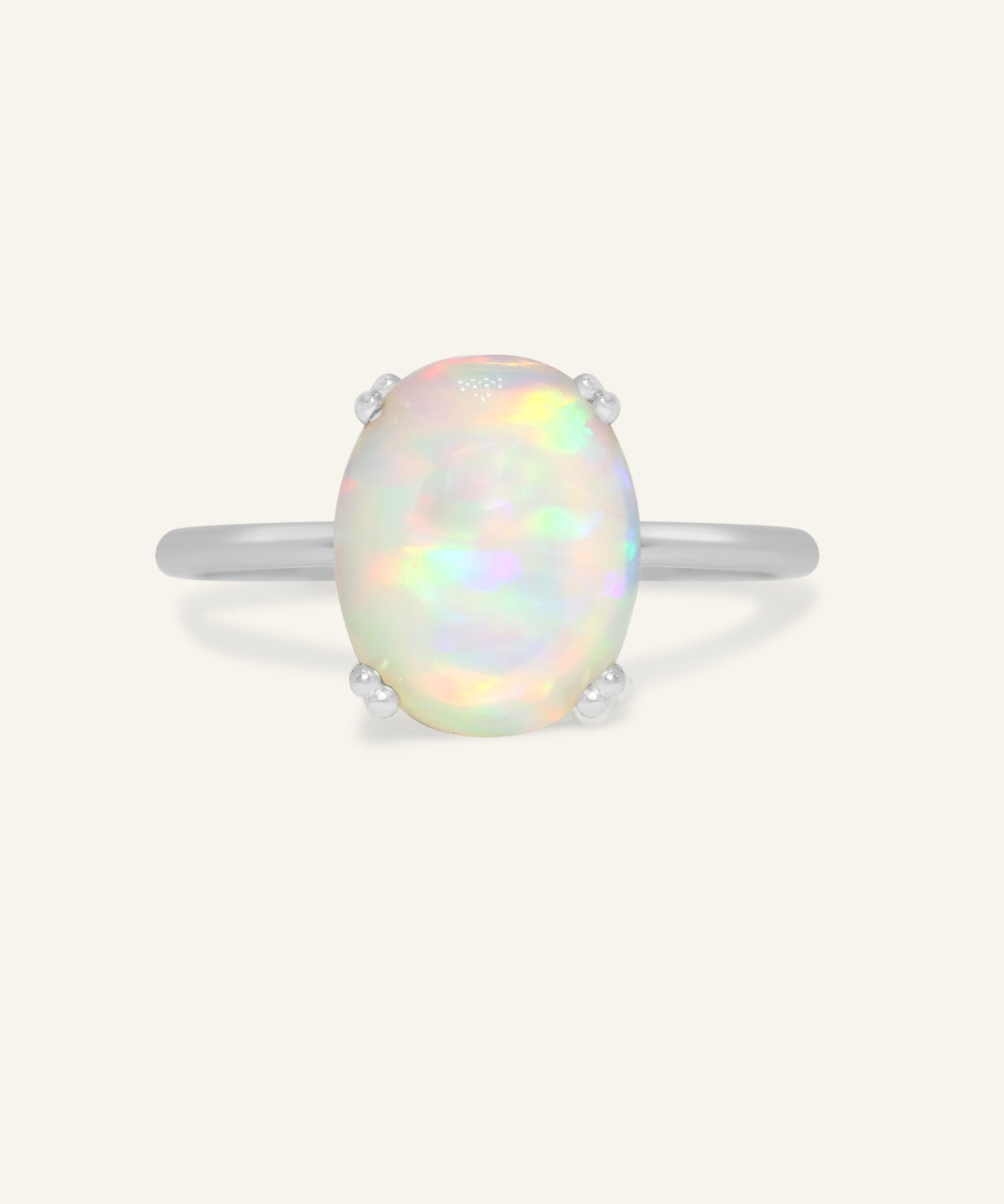 Luna Ethiopian Opal Ring in silver, front view of the oval opal ring on warm ivory