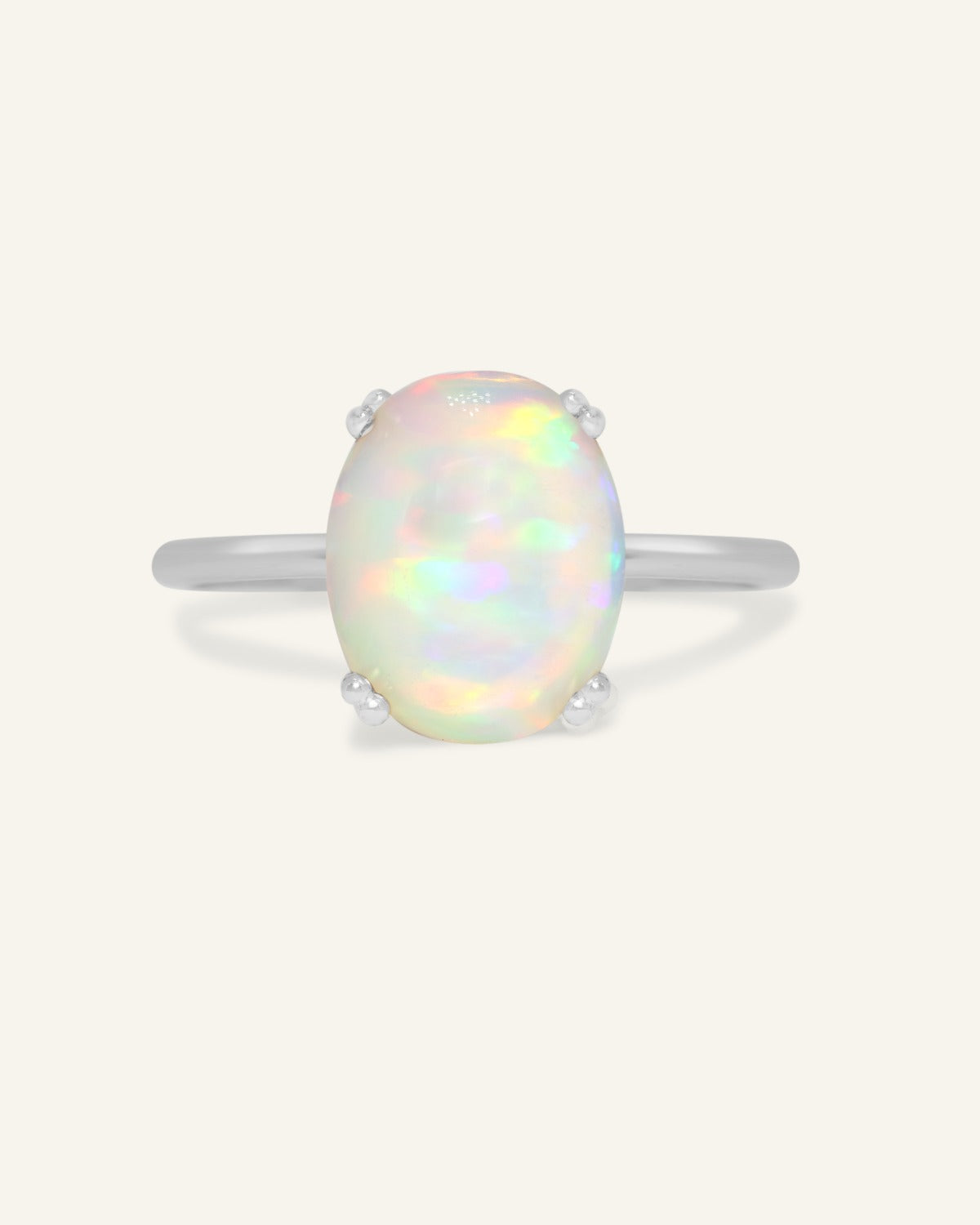 Luna Ethiopian Opal Ring in silver, front view of the oval opal ring on warm ivory