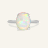 Luna Ethiopian Opal Ring in silver, front view of the oval opal ring on warm ivory