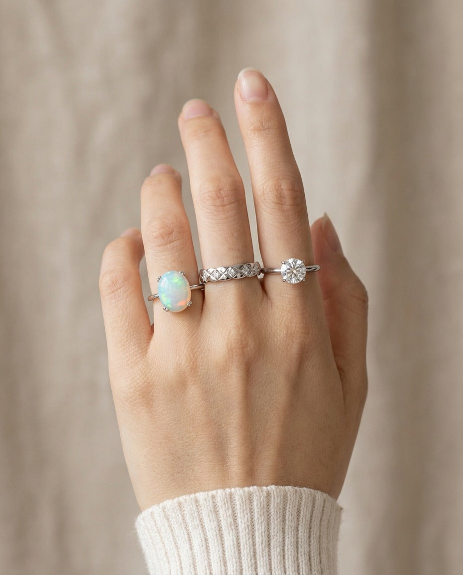Luna Ethiopian Opal Ring in silver, worn on an open hand with two silver rings