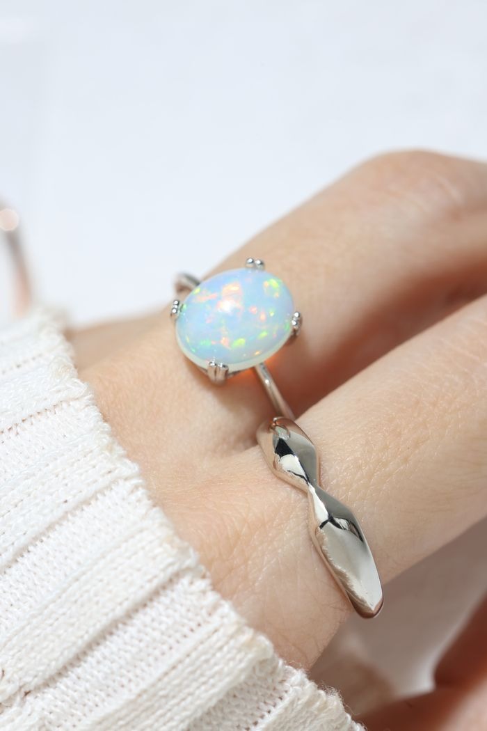 Luna Ethiopian Opal Ring in silver, close-up of the opal worn on a hand in daylight