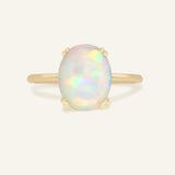 Luna Ethiopian Opal Ring in yellow gold, front view of the oval opal ring on warm ivory