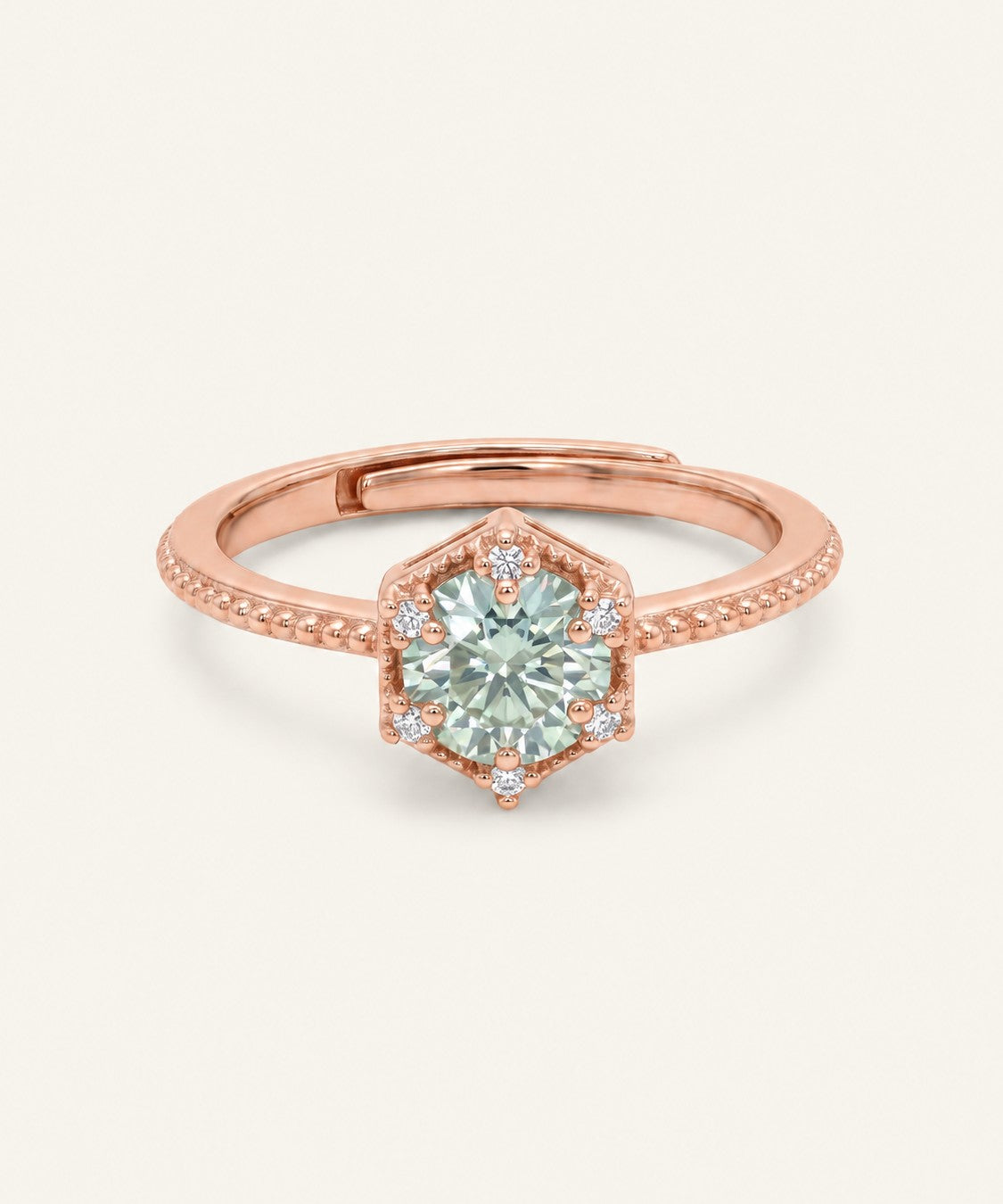 Rose gold mint green moissanite ring with a floral CZ halo on an ivory background