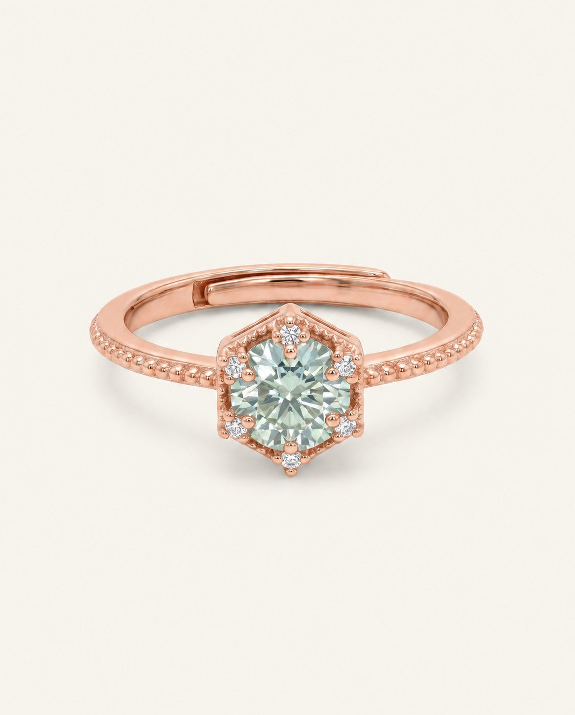 Rose gold mint green moissanite ring with a floral CZ halo on an ivory background