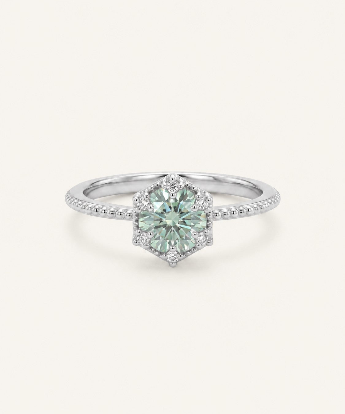 Silver mint green moissanite ring with a floral CZ halo on an ivory background