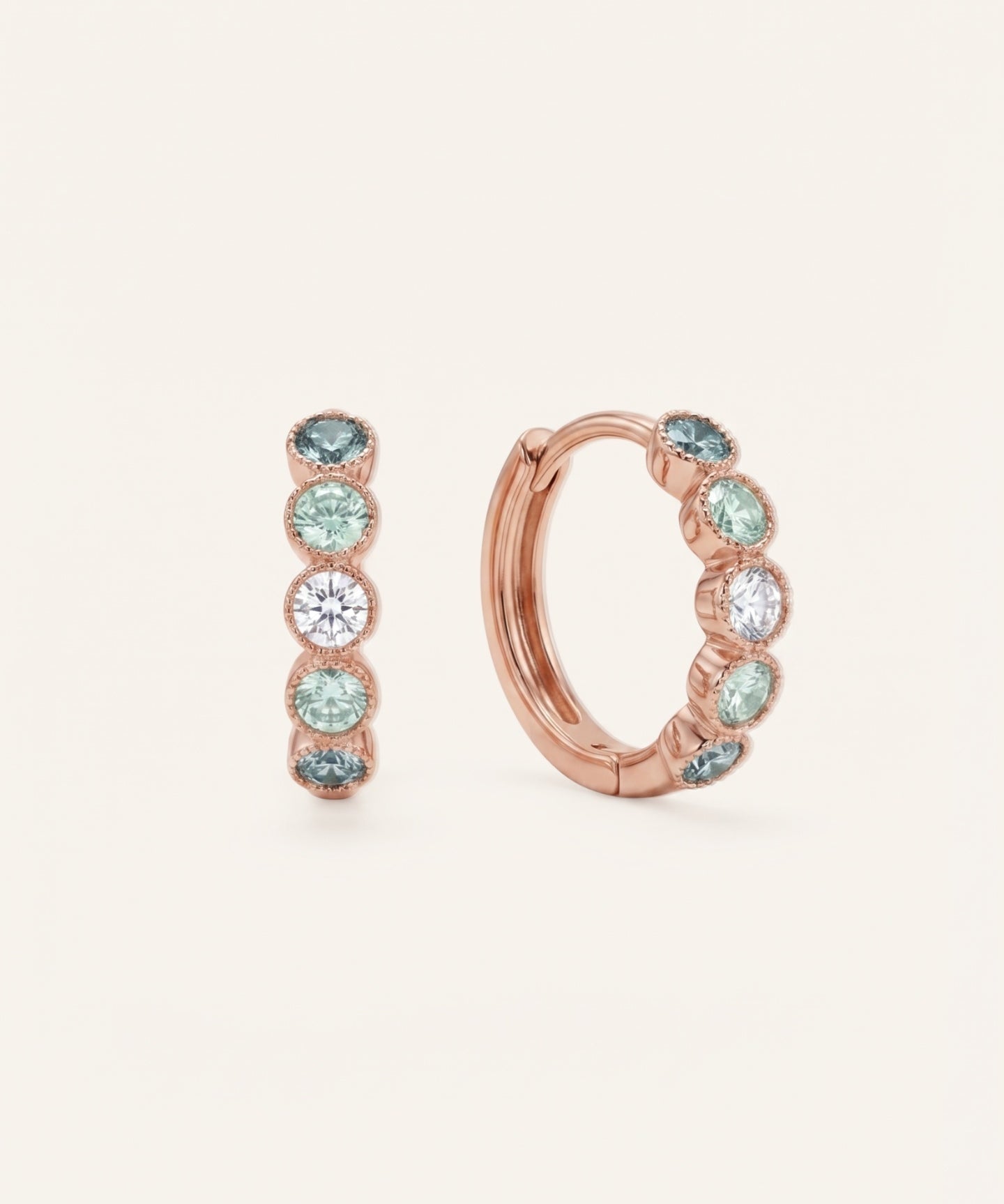 Pair of mint ombré moissanite hoop earrings in rose gold on an ivory background