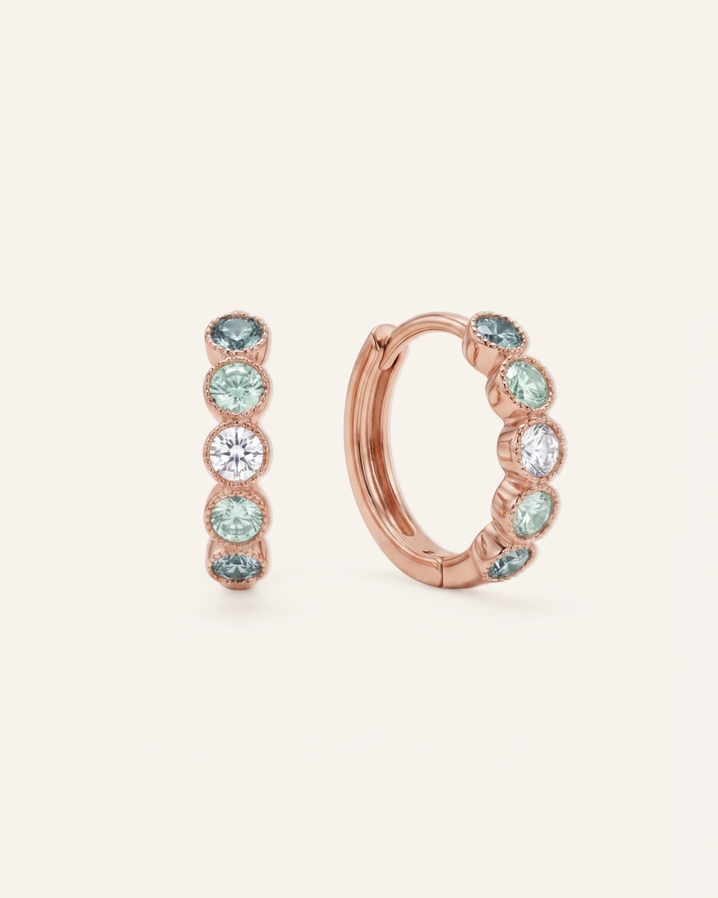 Pair of mint ombré moissanite hoop earrings in rose gold on an ivory background