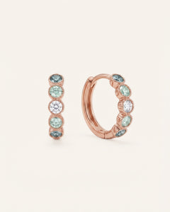 Pair of mint ombré moissanite hoop earrings in rose gold on an ivory background