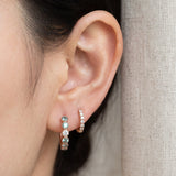 Mint ombré moissanite rose gold hoop earring worn beside a small hoop