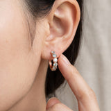 Mint ombré moissanite rose gold hoop earring with a fingertip beside the hoop