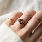 Nocturne Halo Hexagon Ring in rose gold worn on a hand, lab-grown alexandrite showing raspberry-pink tones with black CZ accents