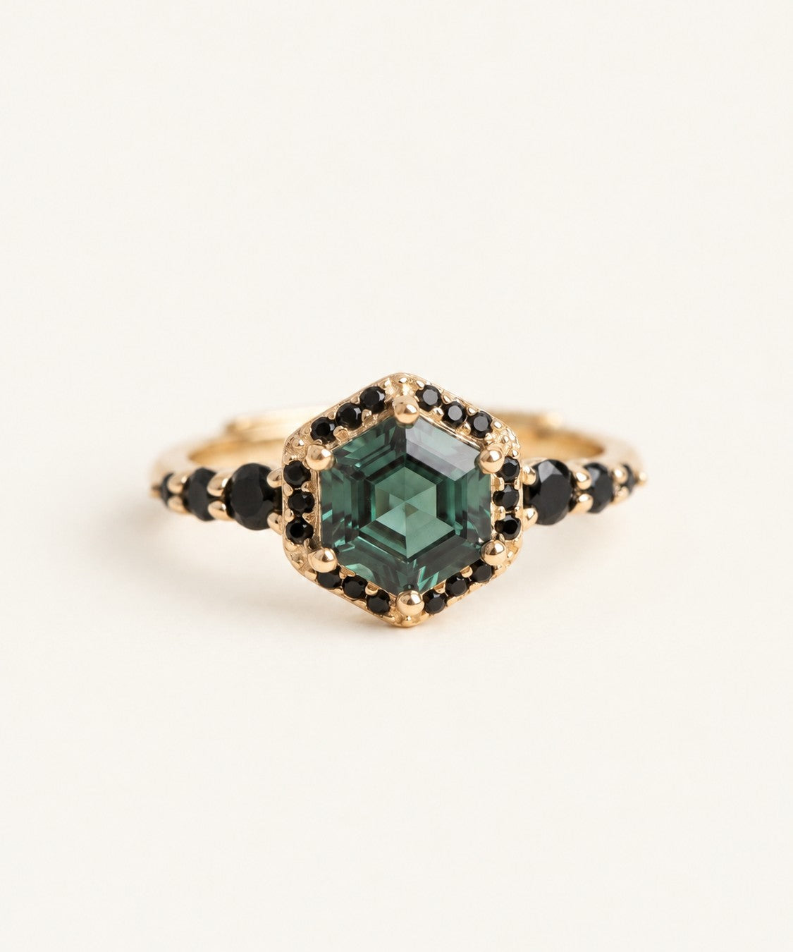 Nocturne Halo Hexagon Ring in yellow gold with green lab-grown alexandrite and black CZ halo on an ivory background