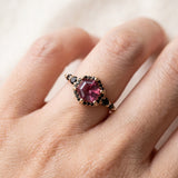 Nocturne Halo Hexagon Ring in yellow gold, lab-grown alexandrite showing raspberry-pink tones with a black CZ halo