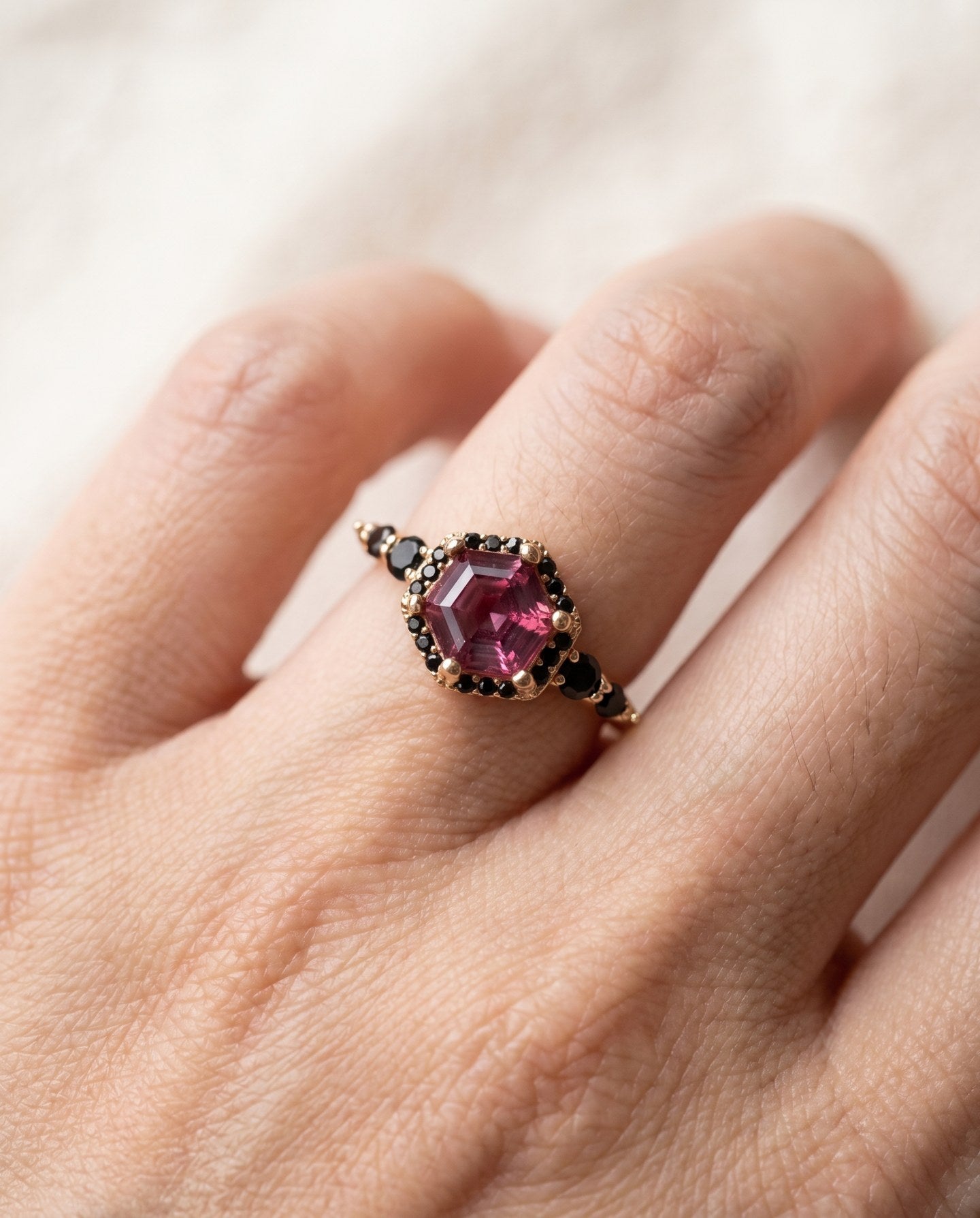 Nocturne Halo Hexagon Ring in yellow gold, lab-grown alexandrite showing raspberry-pink tones with a black CZ halo