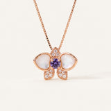 Orchid Bloom Mother of Pearl Necklace in rose gold with iridescent wings and purple spinel centre on a soft ivory background